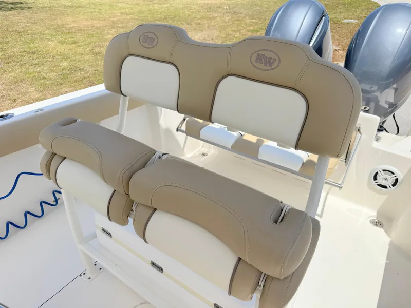 Slide: The Image of 2017 Key West 244 Center Console boat with beige cushioned seating and dual engines. - 19