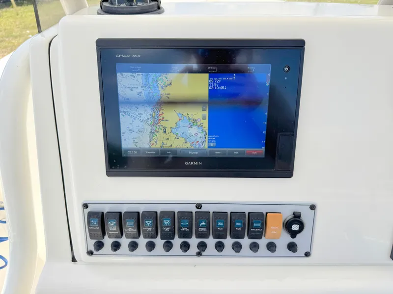 Slide: The Image of 2017 Key West 244 Center Console boat dashboard with Garmin GPS and control panel. - 23