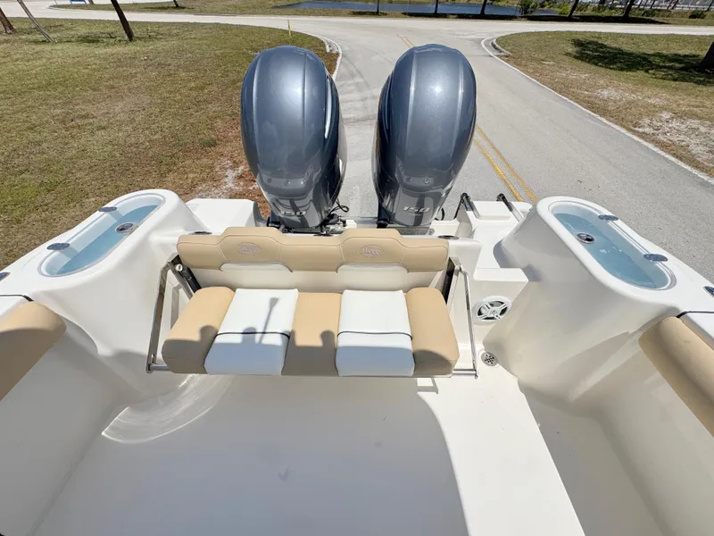 Slide: The Image of 2017 Key West 244 Center Console boat with dual outboard motors and seating area. - 25