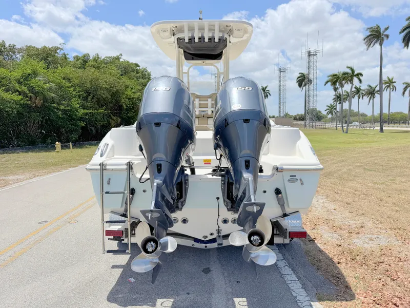 Slide: The Image of 2017 Key West 244 Center Console boat with dual outboard engines on a sunny day. - 3