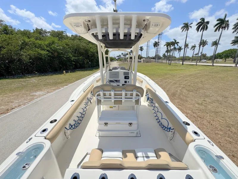Slide: The Image of 2017 Key West 244 Center Console boat on a sunny day, surrounded by palm trees. - 32