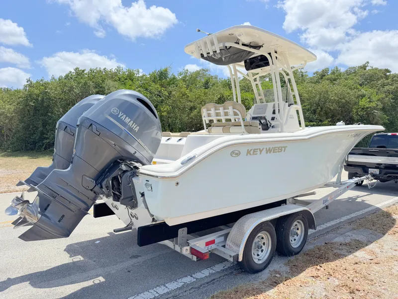 Slide: The Image of 2017 Key West 244 Center Console boat on trailer with Yamaha engine, parked outdoors. - 4