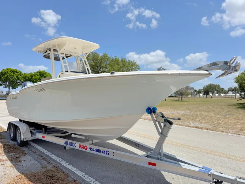 Slide: The Image of 2017 Key West 244 Center Console boat on trailer under blue sky. - 6