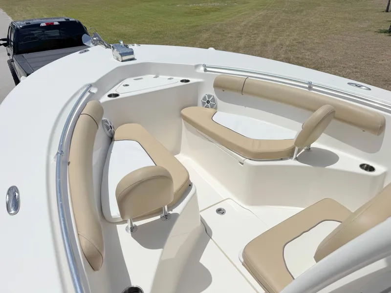 Slide: The Image of 2017 Key West 244 Center Console boat with beige seating and spacious deck. - 7