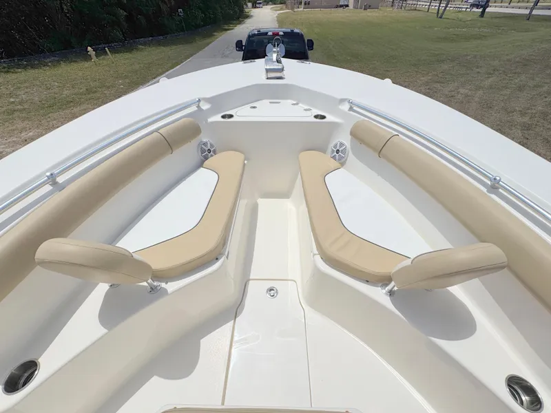 Slide: The Image of 2017 Key West 244 Center Console boat with beige seating and spacious deck layout. - 9