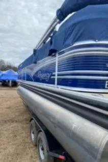 Slide: The Image of 2013 Sun Tracker PARTY BARGE 22 Regency Edition pontoon boat on trailer, covered and parked outdoors. - 4