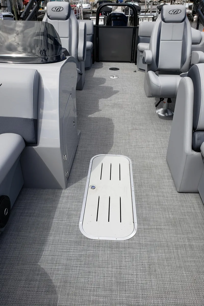 Slide: The Image of 2025 Bentley Pontoons Legacy 243 Navigator Ext interior with gray seating and flooring. - 5