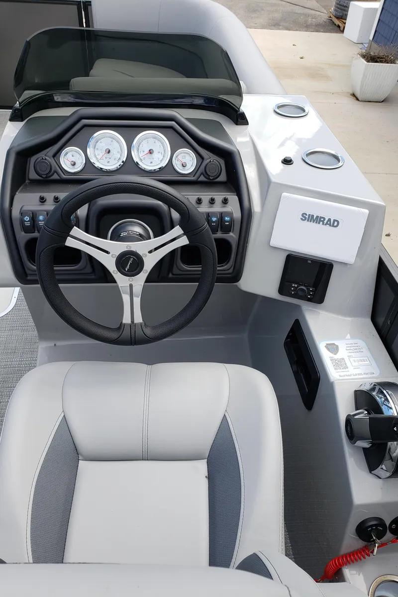 Slide: The Image of 2025 Bentley Pontoons Legacy 243 Navigator Ext dashboard with steering wheel and controls. - 6