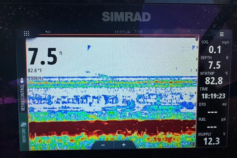 Slide: The Image of Simrad marine display showing depth, water temperature, and sonar data on a 2021 Sea Ray SDX 270. - 14