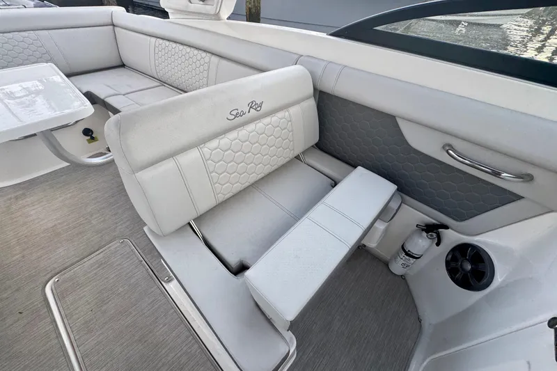 Slide: The Image of 2021 Sea Ray SDX 270 boat interior with white seating and table. - 17