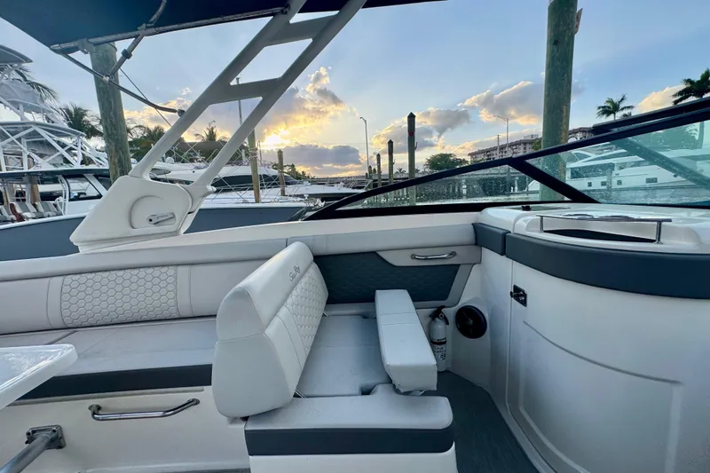 Slide: The Image of 2021 Sea Ray SDX 270 boat interior with sunset view at marina. - 21