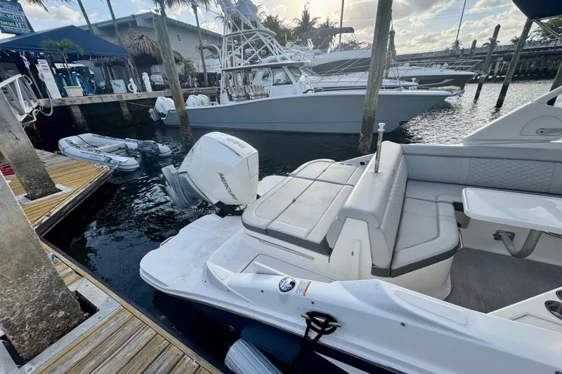 Slide: The Image of 2021 Sea Ray SDX 270 boat docked at marina with other vessels. - 30