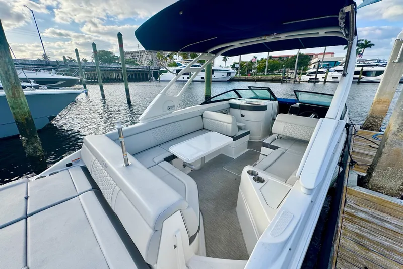 Slide: The Image of 2021 Sea Ray SDX 270 boat with spacious seating, docked at a marina. - 4