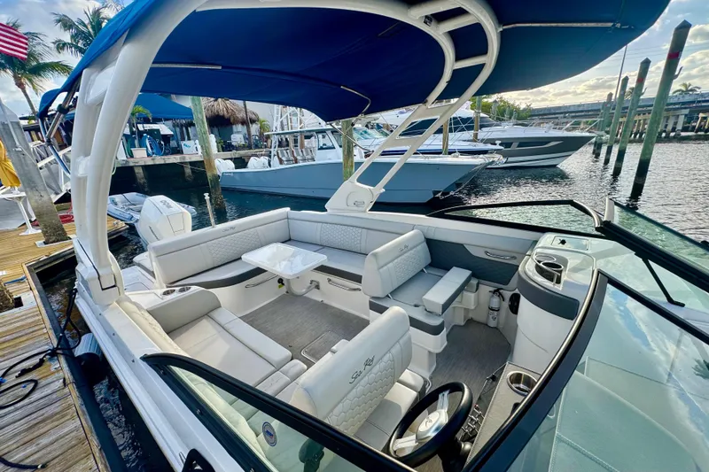 Slide: The Image of 2021 Sea Ray SDX 270 boat with spacious seating and canopy docked at marina. - 6