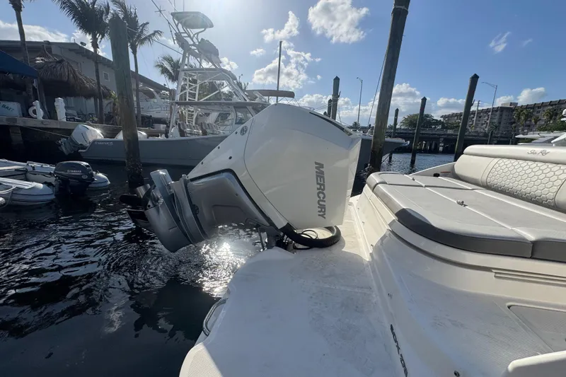 Slide: The Image of 2021 Sea Ray SDX 270 boat with Mercury outboard engine docked at marina. - 8