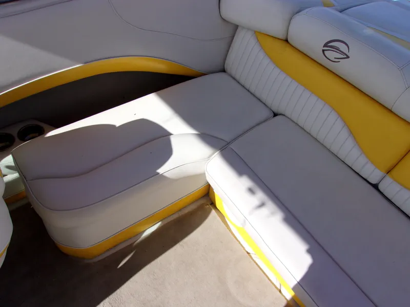 Slide: The Image of 2007 Crownline 23SS boat interior with yellow and white seating. - 10