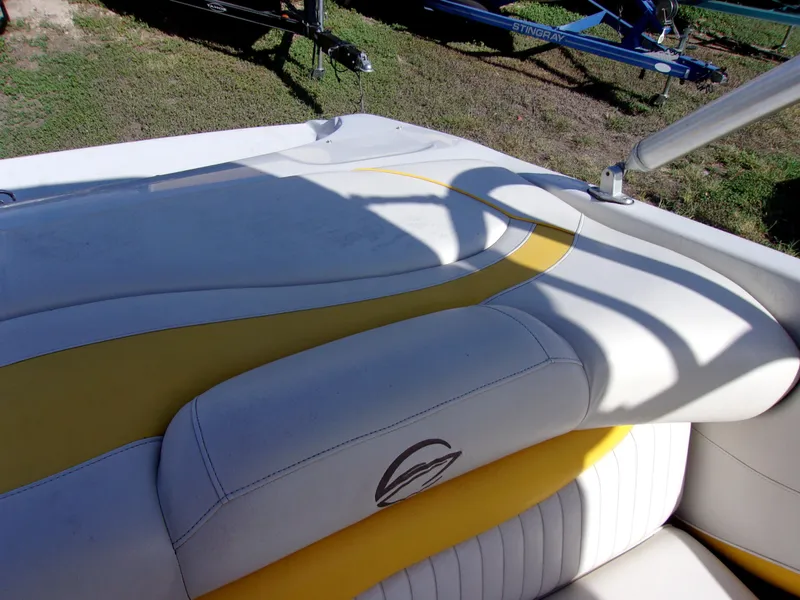 Slide: The Image of 2007 Crownline 23SS boat interior with yellow and white seating, featuring a sleek design. - 13