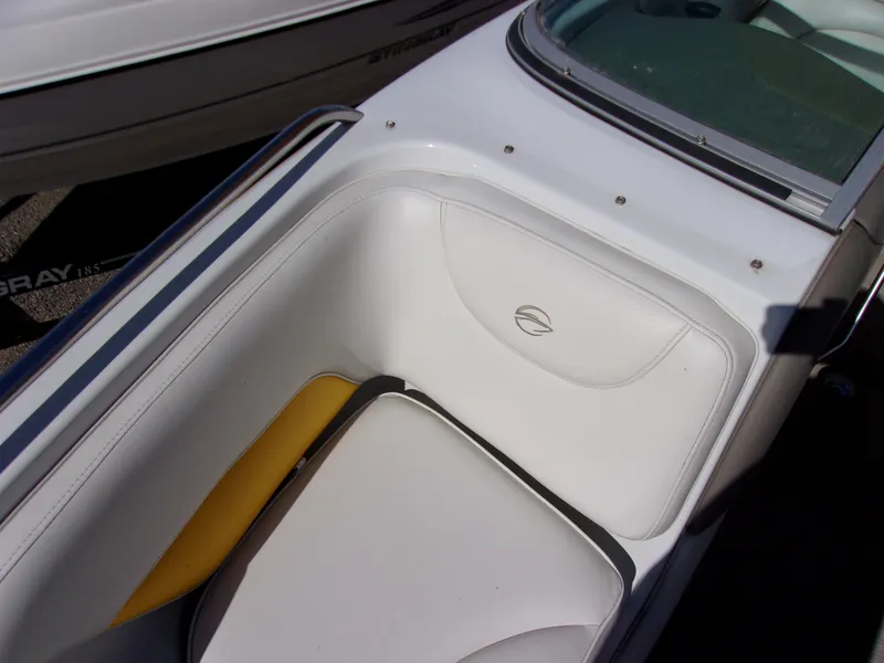 Slide: The Image of 2007 Crownline 23SS boat interior with white and yellow seating. - 15