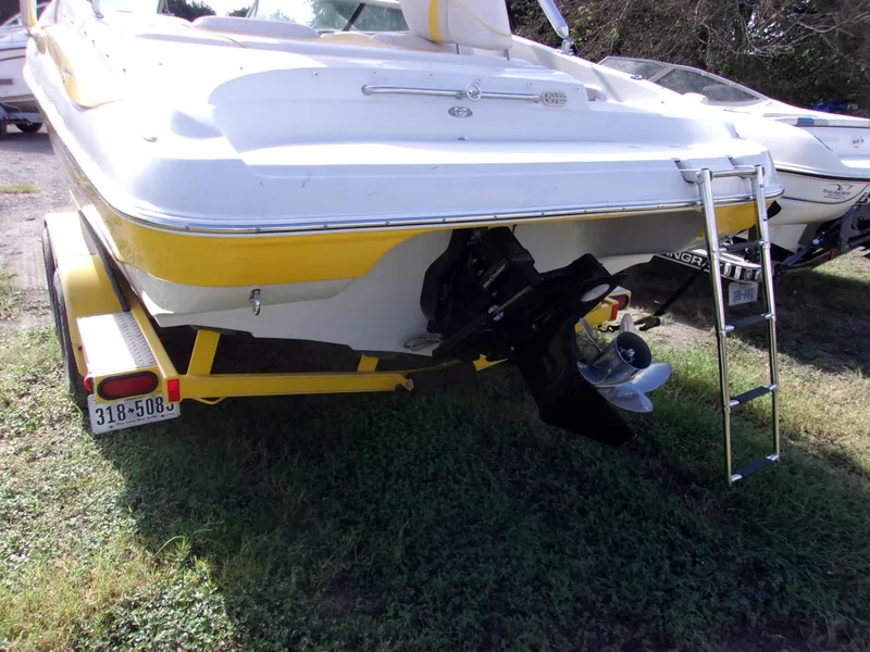Slide: The Image of 2007 Crownline 23SS boat, yellow and white, rear view with trailer and ladder. - 4
