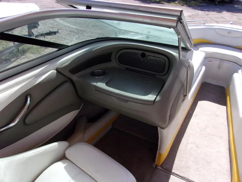 Slide: The Image of 2007 Crownline 23SS boat interior with seating and dashboard, featuring gray and yellow accents. - 6