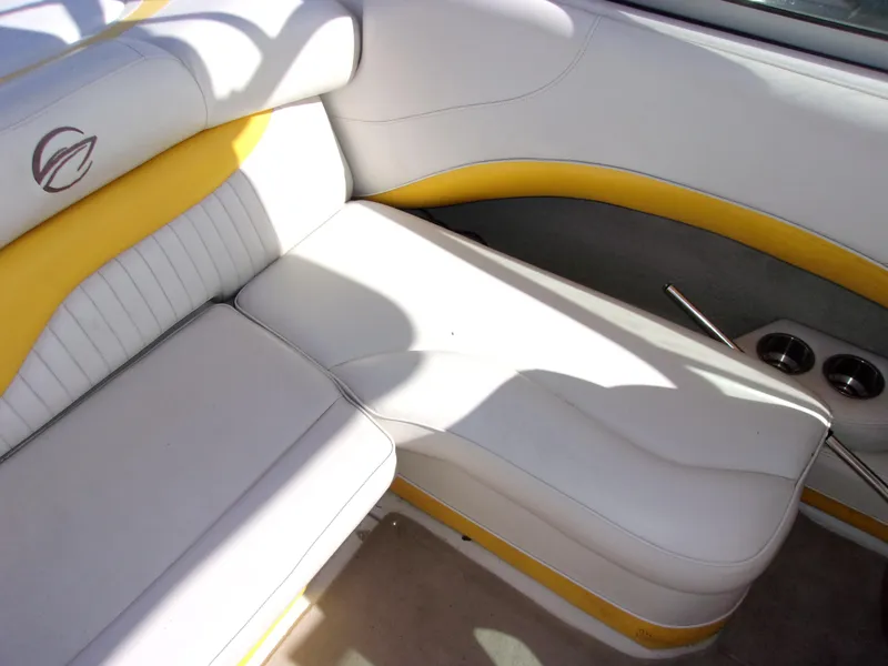 Slide: The Image of 2007 Crownline 23SS boat interior with white and yellow seating, cup holders, and logo detail. - 9