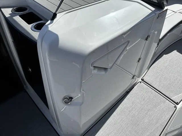 Slide: The Image of 2025 Yamaha Boats AR250 interior with sleek white panel and cup holders. - 10