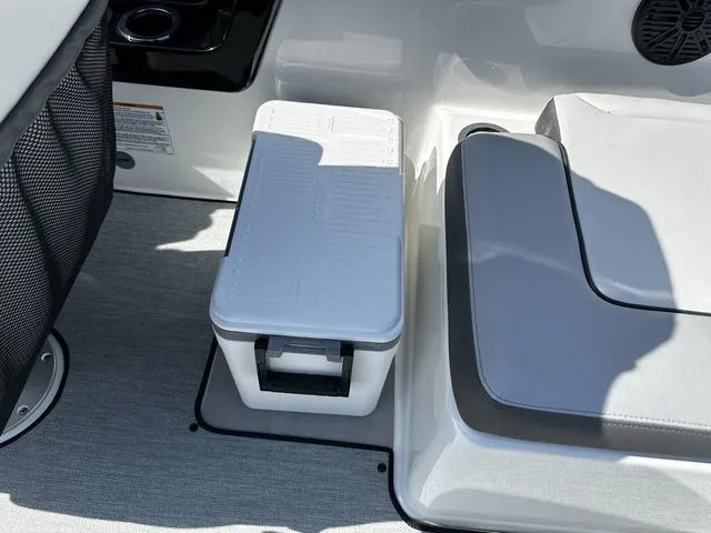 Slide: The Image of 2025 Yamaha AR250 boat interior with seating and a portable cooler. - 16