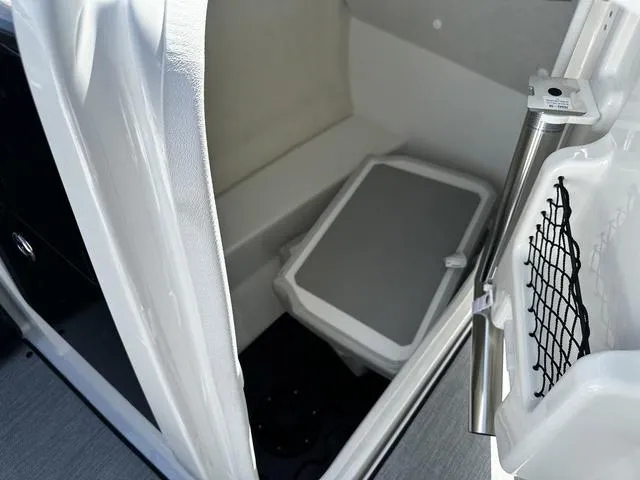 Slide: The Image of Interior of 2025 Yamaha AR250 boat, featuring a compact storage compartment. - 17
