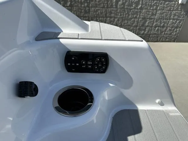 Slide: The Image of 2025 Yamaha AR250 boat interior with control panel and cup holder. - 6