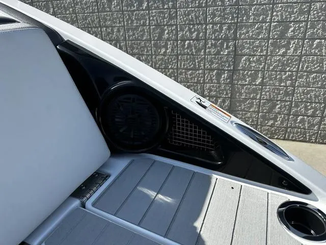 Slide: The Image of 2025 Yamaha Boats AR250 interior detail with speaker and cup holder. - 7