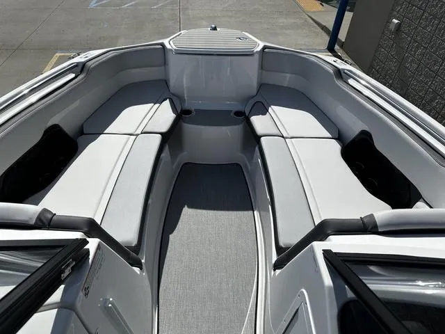 Slide: The Image of 2025 Yamaha Boats AR250 interior with spacious seating and modern design. - 9