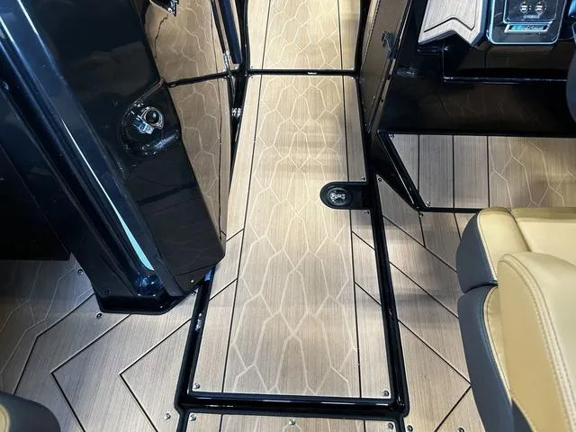 Slide: The Image of 2025 Yamaha Boats 255XD interior with sleek wood-patterned flooring and modern design. - 14