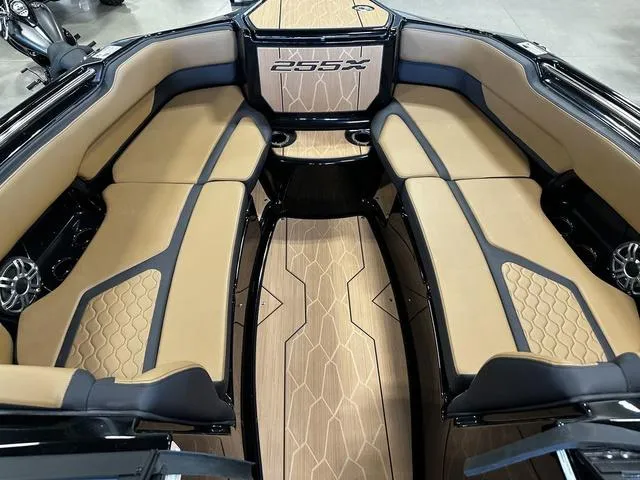 Slide: The Image of Interior of 2025 Yamaha Boats 255XD, featuring tan and black seating with stylish design. - 16