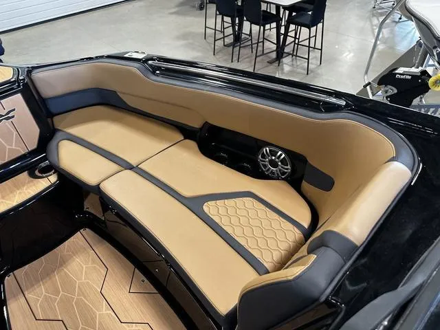 Slide: The Image of Luxurious interior of 2025 Yamaha Boats 255XD with tan and black seating. - 18