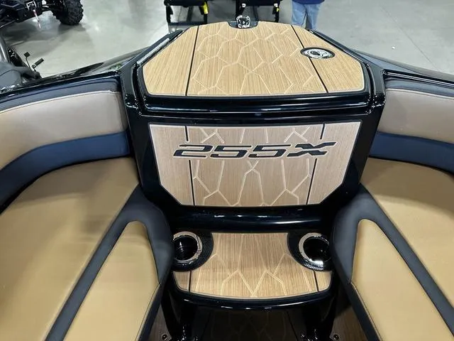 Slide: The Image of 2025 Yamaha Boats 255XD interior with stylish wood finish and seating. - 19