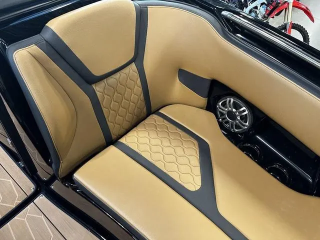 Slide: The Image of Luxurious interior seating of 2025 Yamaha Boats 255XD with stylish tan and black design. - 22