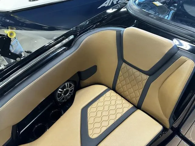 Slide: The Image of 2025 Yamaha Boats 255XD interior with tan and black seating, featuring stylish hexagonal patterns. - 23