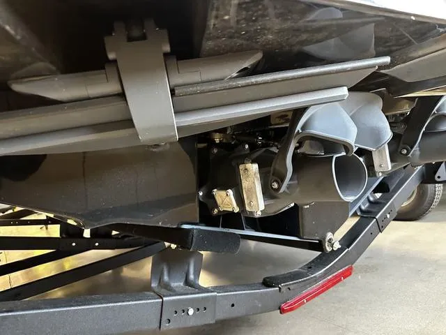 Slide: The Image of 2025 Yamaha Boats 255XD underside view, showcasing jet propulsion system and trailer components. - 26