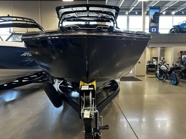 Slide: The Image of 2025 Yamaha Boats 255XD displayed indoors, front view on trailer. - 3