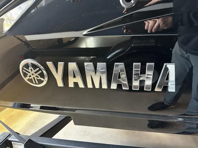 Slide: The Image of Close-up of 2025 Yamaha Boats 255XD logo on sleek black surface. - 6