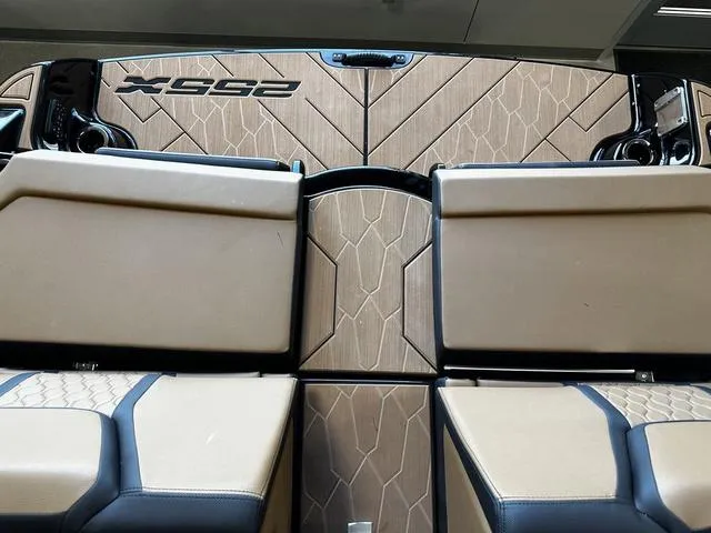 Slide: The Image of 2025 Yamaha Boats 255XD interior with tan and black seating, featuring stylish design elements. - 7