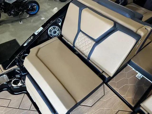 Slide: The Image of 2025 Yamaha Boats 255XD interior with beige and black seating, featuring modern design and speaker system. - 9