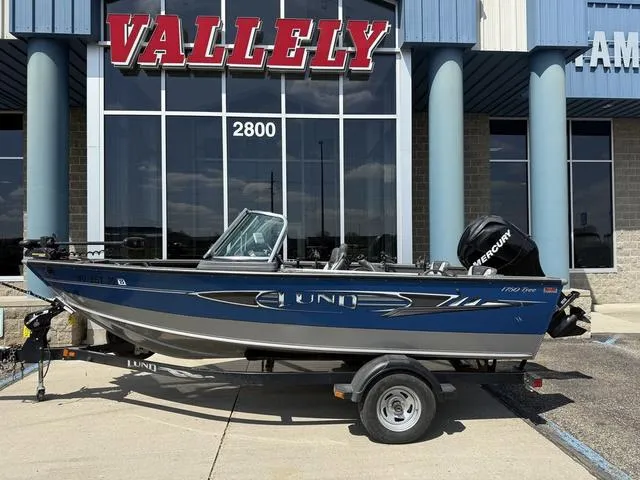 Slide: The Image of 2012 Lund 1750 Tyee boat on trailer outside Vallely building. - 1