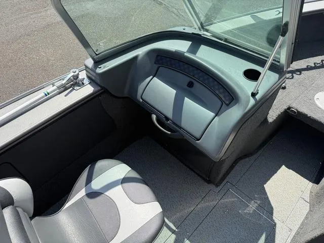 Slide: The Image of Interior of a 2012 Lund 1750 Tyee boat, featuring seating and dashboard. - 10