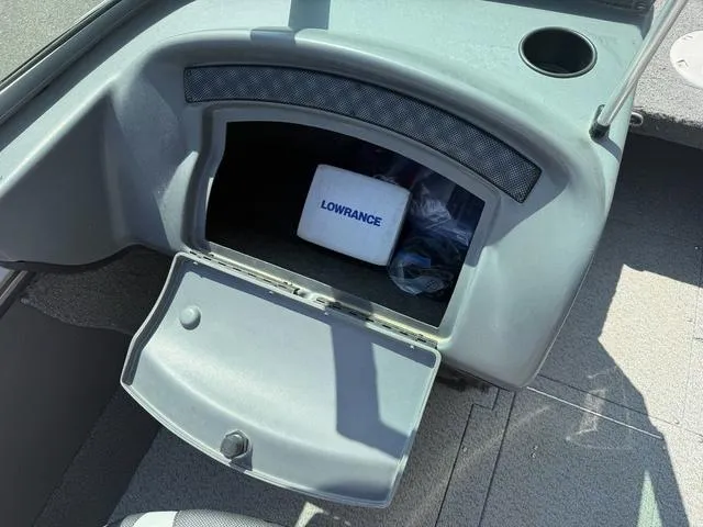 Slide: The Image of Open glove compartment in a 2012 Lund 1750 Tyee boat with Lowrance equipment inside. - 11