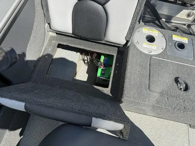 Slide: The Image of 2012 Lund 1750 Tyee boat interior showing battery compartment under seat. - 13