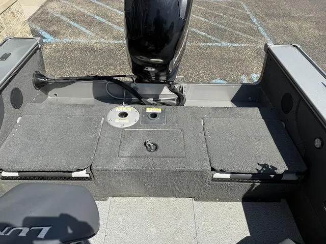 Slide: The Image of 2012 Lund 1750 Tyee boat interior with motor, showing seating and storage compartments. - 15