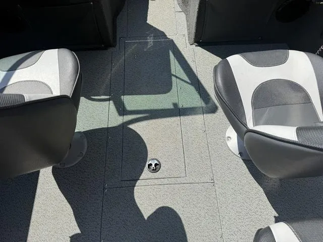 Slide: The Image of Interior of a 2012 Lund 1750 Tyee boat showing two seats and a storage compartment. - 17