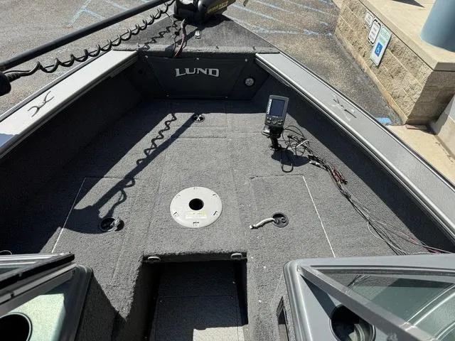 Slide: The Image of 2012 Lund 1750 Tyee boat interior with fishing equipment and control panel. - 19