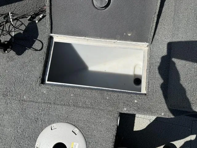 Slide: The Image of Open storage compartment on 2012 Lund 1750 Tyee boat deck. - 21